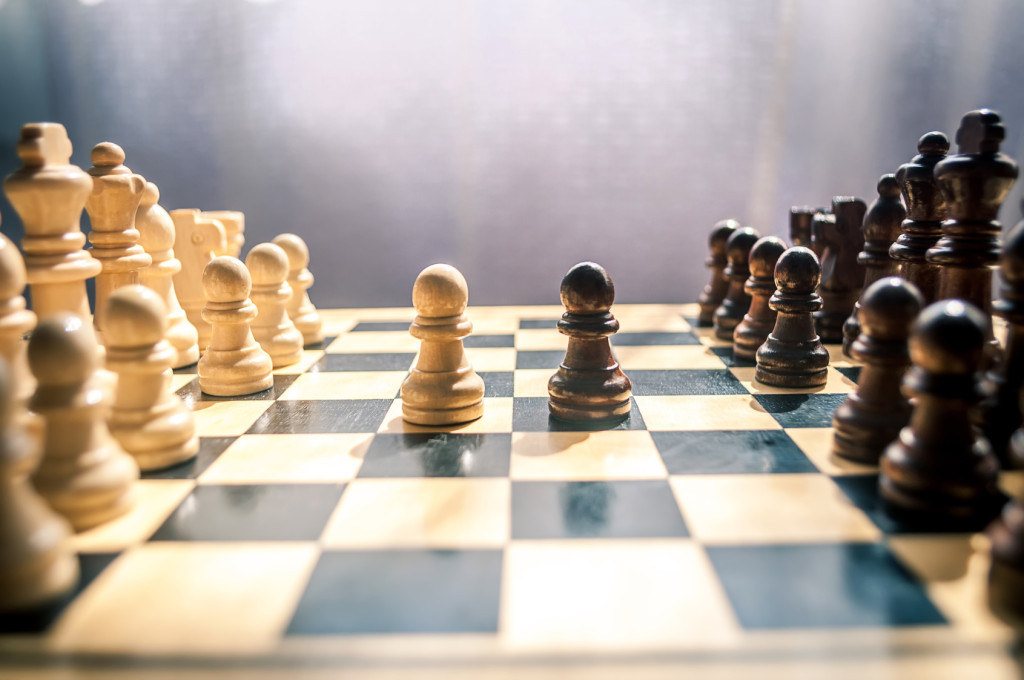 chess black and white pieces on the wooden Board